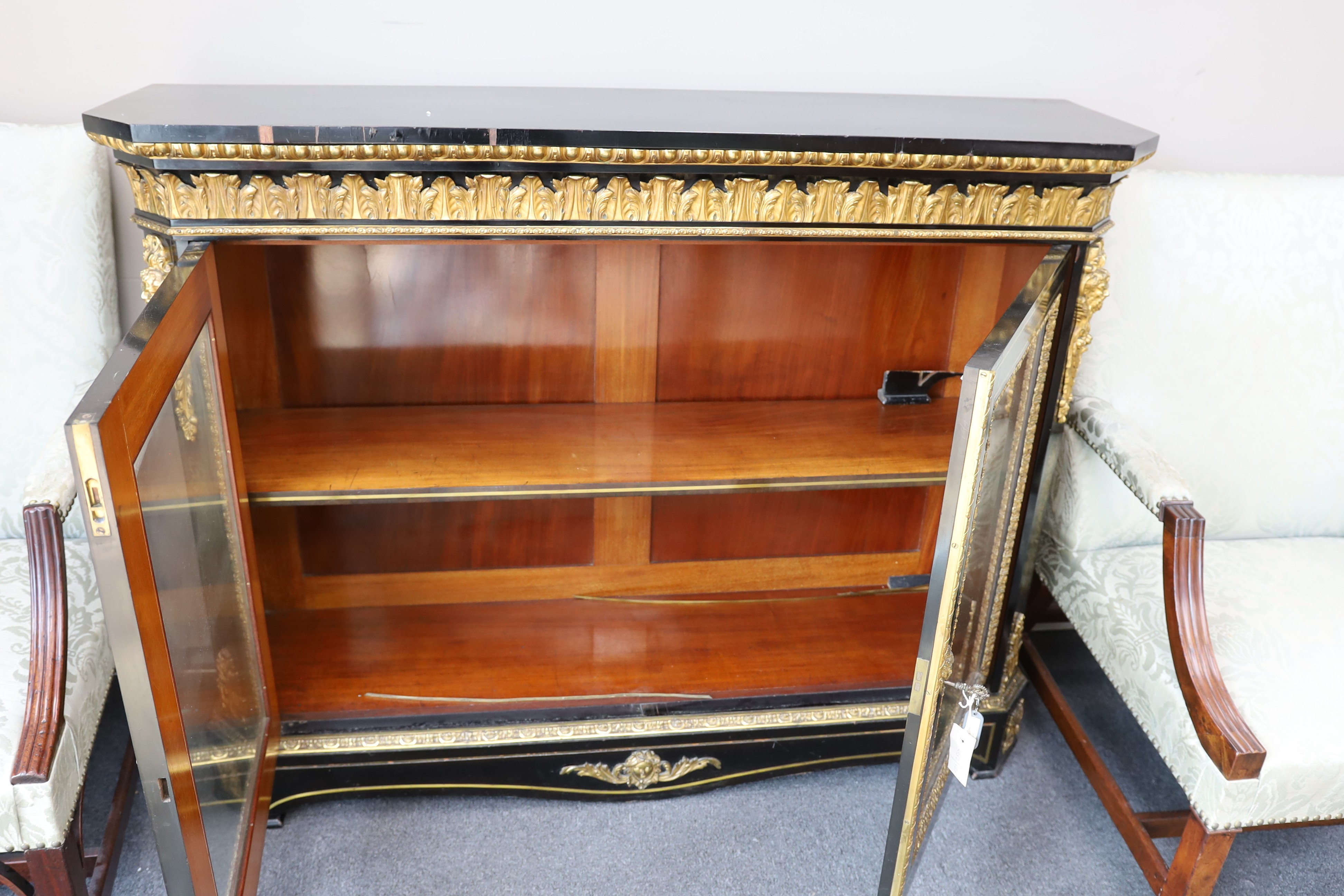 A 19th century French gilt metal mounted ebonised two door side cabinet, width 140cm, depth 38cm, height 107cm